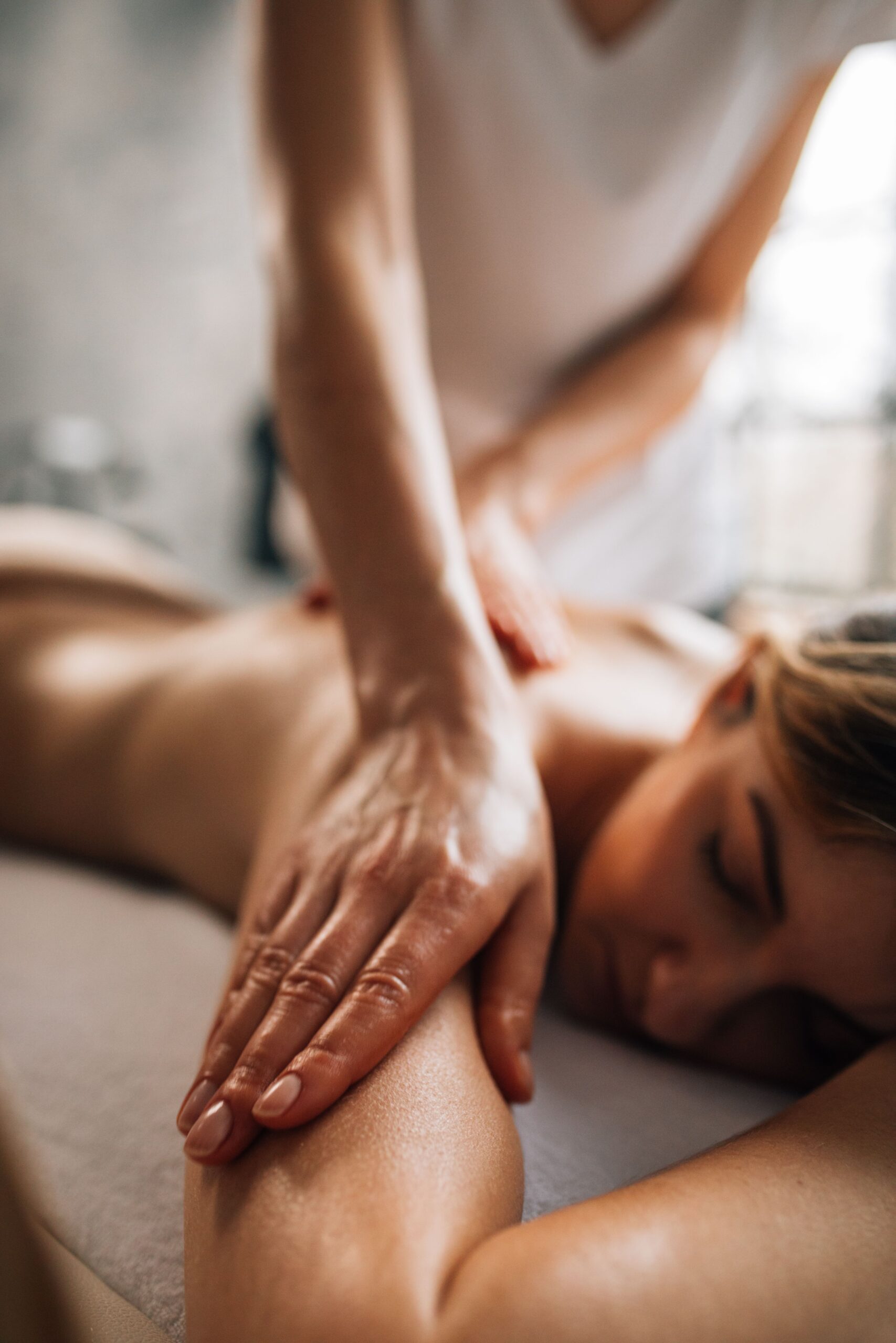 Woman being massaged whilst on a table